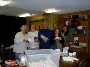 Our Global Mission Committee offers the congregation unique ways of supporting charitable causes both on a local and world-wide basis through creative special offering opportunities. Various items from gently used children's books to bath size bars of soap have been collected and sent to those in need. The picture below was taken as volunteers put together mid-wife kits to aid a global cause. Items for the kits were donated by Pilgrim members.
